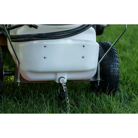 Rear view of Tow-Behind Garden Sprayer With 15 Gallon Tank, 30 Inch Boom, 1.6 GPM At 100 PSI showing tank drain in garden setting