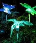 Solar Garden Lights Outdoor Set Of 6 Insect Stake Lights with LED beams featuring butterfly, hummingbird, and dragonfly at night