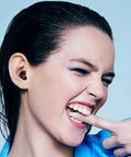 Person wearing Experience 2 Ear Plugs For Concerts And Festivals With High Fidelity Hearing Protection, 17dB Noise Reduction
