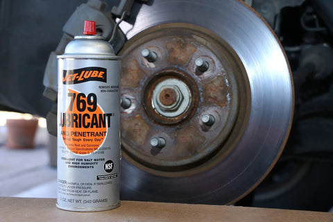 Multipurpose Penetrating Lubricant Aerosol That Digs In Non Flammable Military Grade Rust Inhibitor And Moisture Displacer Tough Corrosion Preventative No Fluorocarbons CO2 Propellant Pack Of 12 Units next to car brake disc