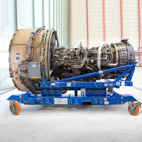 Eight By Two Inch Tough As Nails Heavy Duty Swivel Casters Using Kingpinless Crowned Polyurethane Tread And Aluminum Core Carry Up To Twelve Thousand Lbs on a blue mobile platform with engine.