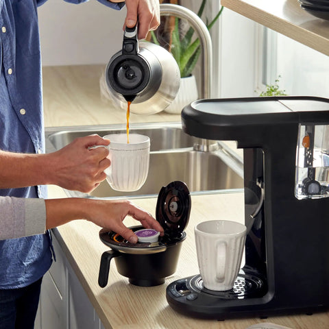 Person brewing coffee with 12-cup programmable maker and Advanced Water Filter Cartridges For 12-Cup Programmable Coffee Makers, 2 Pack White