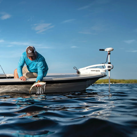 Man fishing from a boat using the Badass Saltwater Workhorse Rock Solid Bow Mount Electric Trolling Motor With Digital Maximizer.