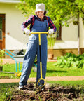 Woman using Manual Twist Tiller For Gardening With Seventeen Inch Arc Handle And Ergonomic Grip Garden Claw Cultivator in a yard.