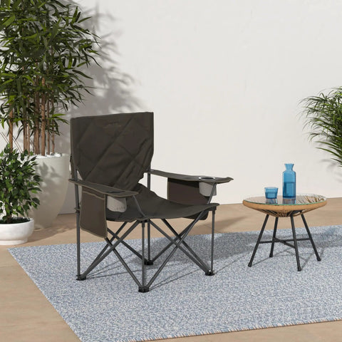 King Kong Camping Chair For Adults With Mesh Cup Holders And Extra Pockets on a patio, surrounded by plants and table.