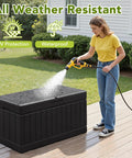 78 Gallon Waterproof Resin Deck Box With Lockable Bench being cleaned with a hose on a patio, showcasing all-weather durability.
