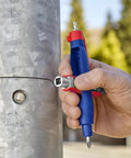 Universal Control Cabinet Key Pen Style With Clip Featuring Four Key Profiles for utility access, held next to a metal control box outdoors