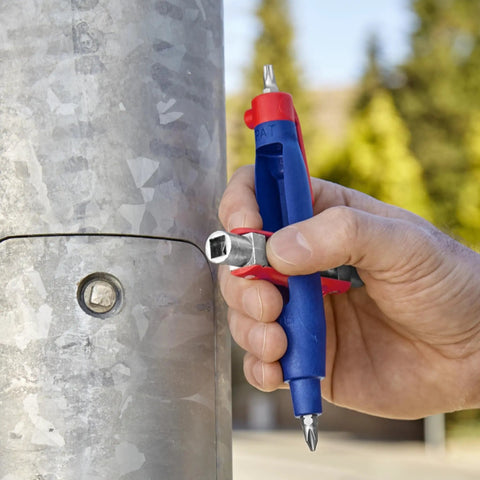 Universal Control Cabinet Key Pen Style With Clip Featuring Four Key Profiles for utility access, held next to a metal control box outdoors