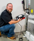 Technician installing CP-22 Series Go-To Automatic Condensate Pump For HVACR Equipment With Removable Check Valve 120V 22-Foot Lift