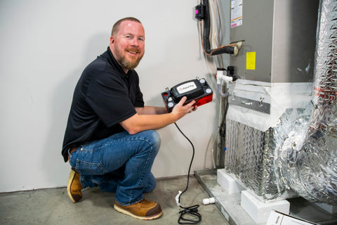 Technician installing CP-22 Series Go-To Automatic Condensate Pump For HVACR Equipment With Removable Check Valve 120V 22-Foot Lift