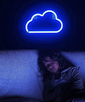 Child sleeping under blue cloud-shaped neon light. Heart Angel Wings Neon Sign For Teens And Girls Room Decor USB Powered Neon Light With On Off Switch Cute Vibe For Desks Dresser Dorm Rooms And Wall Art 14 By 4 Point 5 Inch LED Sign.