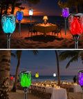 Outdoor RGB Solar Flame Lights 4 Pack With Seven Color Flickering Fire Effect illuminating beachside dinner setting