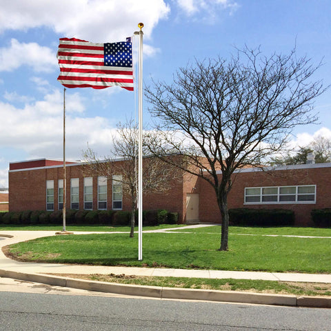 Heavy Duty 25 Foot Flag Pole Kit With 3x5 Foot US Flag Aluminum Outdoor Flagpole With Gold Ball Top weatherproof in front of a building
