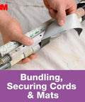 Person using No Residue Duct Tape 1.88 Inch By 20 Yards Grey 2420A on cords and pipes demonstrating bundling use.