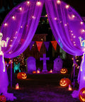 Two 15.7 Inch Hanging Skeleton Decorations With Full Body Posed Joints in Halloween graveyard scene with lights and pumpkins