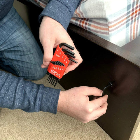 Man using SAE Hex Key Set In Inch Sizes From.050 To 1/4, 11 Pc Short Series Allen Wrenches For Internal Hex Drive, Industrial Grade Tools Made In USA for furniture assembly