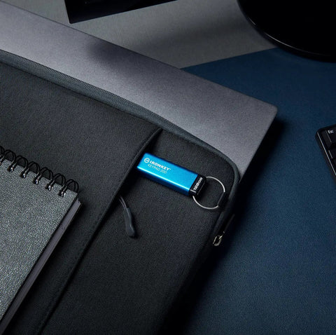 Rock Solid 16Gb Encrypted Usb Drive With Alphanumeric Keypad Lock displayed on a laptop bag next to a notebook.