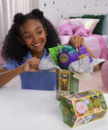 Child unboxing Unbox Wicked Ozian Balloons Reveal Toy Set With Surprise Mini Doll Inside Each Balloon on table.