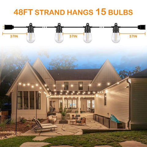 Outdoor LED String Lights 96 Ft Shatterproof And Waterproof IP65 With Replaceable Bulbs illuminating a backyard patio setup