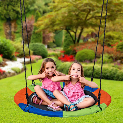 Two kids playing on 40 Inch Kids Saucer Tree Swing Set With 600D Heavy Duty Oxford Fabric Platform Seat, outdoor view