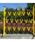 Heavy Duty Expandable Telescopic Barrier With Rolls Like Butter Stoppable Wheels Adjustable Retractable Traffic Fence in yellow and black.