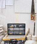 Nine Drawer Plastic Storage Cabinet for tools on workbench in home workshop, clear-view drawers with easy access compartments.