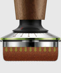 Pro Grade Digital Espresso Tamper Nails Your Perfect 58Mm Puck, showing solid walnut grip and force gauge with coffee grounds.