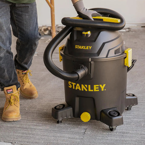 10 Gallon Wet Dry Shop Vacuum With 6 Peak HP Motor And Built In Drain being used on a concrete floor, large capacity cleaner