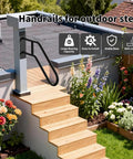 Heavy Duty U Shaped Hand Rail For Outdoor Steps, Black Wall Mount Stair Support With No Sweat Install Kit, Built Tough Design For Reliable Front Porch And Backyard Deck Grip mounted on wooden steps surrounded by flowers.