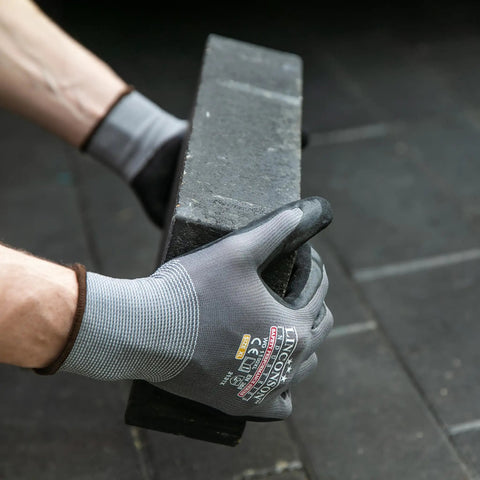 Hands wearing Linconson Safety Performance Series Work Gloves lifting a block, showcasing durable grip and breathable flex. Size Large.