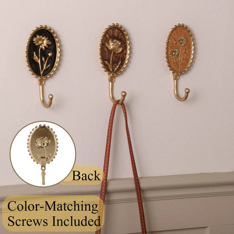 Super Clean Set Of Three Straight Up Vintage Wall Hooks With French Garden Floral Details And Classic Scalloped Metallic Hardware For Entryway Organizing And Cozy Bedroom Vibes, showcasing floral designs and hooks.