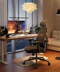 Ergonomic Office Chair With Auto Following Lumbar Support next to a desk setup with a computer and lamp in a cozy room