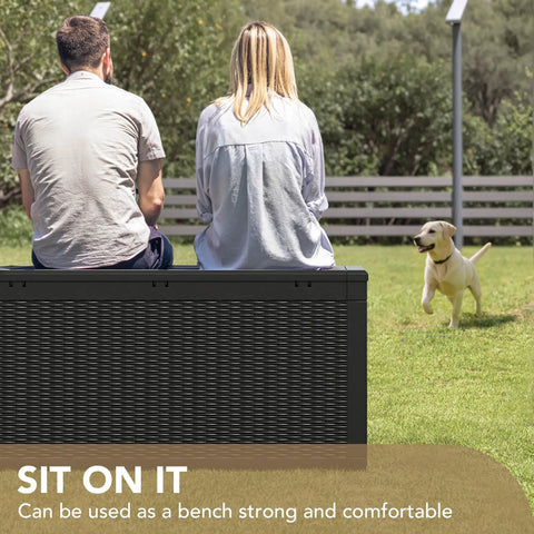 People sitting on a 100 Gallon Waterproof Resin Deck Box With Lockable Lid For Patio Cushions And Garden Tools, Large Outdoor Storage Chest For Indoor Or Outdoor Use Black Weatherproof in a garden.