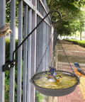 Solid As A Rock Heavy Duty Deck Hooks For Hanging Flower Baskets Bird Feeders And String Lights fitted on metal railing with birds bathing.