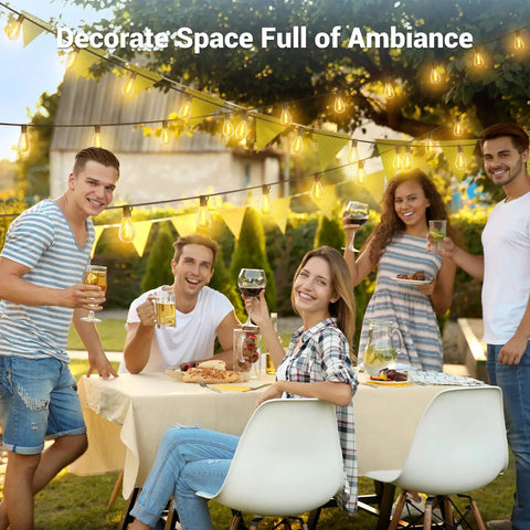 Friends enjoying outdoor dinner under 200 Foot Solar String Lights Outdoor Waterproof With Remote Control, warm ambiance lighting.
