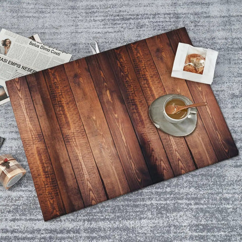 Overhead view of Vertical Wood Grain Dish Drying Mat 18 By 24 Inches Reversible Microfiber Absorbent Pad For Kitchen Counter And Coffee Bar Drying Mat Non Slip Heat Resistant Quick Water Pickup For Easy Cleanup with coffee cup and newspaper.