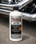 Bottle of Metal Polish With Long Lasting Sealant Cleaner Polisher Protectant All In One beside motorcycle chrome pipes