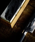 Toishi Sharpening Whetstone With 1000 And 3000 Grit For Knife Edge Maintenance on bamboo stand with chef's knife beside it