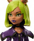 Close-up of Clawdeen Wolf Dawn Of The Dance Reproduction Doll with green hair and purple zip dress.