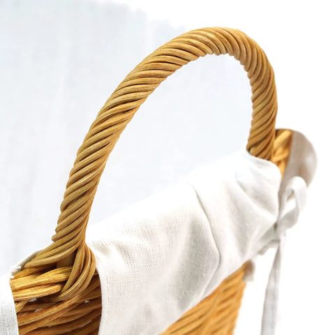 Close-up of a handle on the Rattan Laundry Basket With Easy Carry Handles And Removable White Cotton Liner, Natural Wicker Hamper