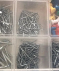 Total Boss 1000 Piece Hardware Assortment Kit With Push Pins Thumb Tacks Upholstery Nails Wire Brads And Drywall Fasteners packed in organizer case.