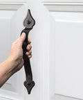 Hand holding part of Magnetic Garage Door Hardware Kit 6 Piece Made From UV Stabilized ABS Plastic No Rust Or Flake Kid And Pet Safe Includes Two 12-Inch By 2-Inch Magnetic Handles For Quick Easy Install
