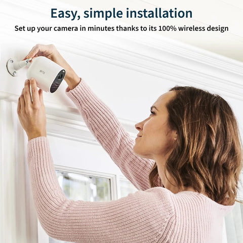 Woman installing Essential Wireless Security Camera With 1080p HD Video, Color Night Vision, 2 Way Audio, Quick Setup
