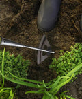 All Steel Hollow Garden Hoe With Long Handle, Heavy Duty Weeding Tool in garden soil, showing hoe pulling weeds and loosening soil