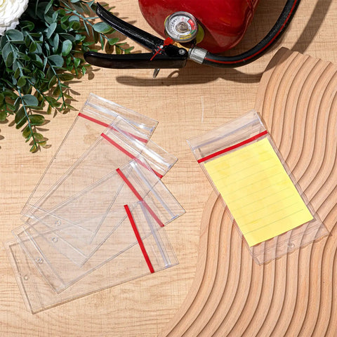 Heavy Duty Resealable Fire Extinguisher Tag Covers 100 Pack Crystal Clear Waterproof Plastic Inspection Sleeves displayed with a notepad.