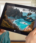 Person holding a Slick 10.1 Inch Windows 11 Tablet Pc Featuring Intel N5100 Quad Core, displaying a beach landscape.