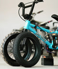 Beefed Up 12.5x2.25 Tire And Inner Tube Set For Scooters And Electric Bikes leaning against a blue bike
