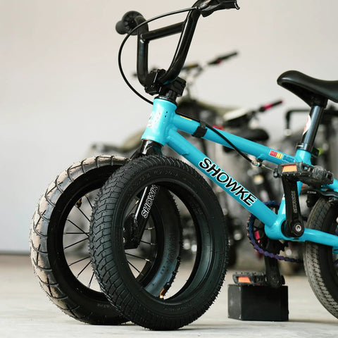 Beefed Up 12.5x2.25 Tire And Inner Tube Set For Scooters And Electric Bikes leaning against a blue bike