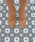 Sevilla Multicolor Peel And Stick Floor Tiles Easy Install No Grout Needed Water Resistant Virgin Vinyl With Textured Low Lustre Finish Durable For Quick DIY Floor Makeover Pack Of Ten Tiles seen beneath brown shoes on Moroccan-style pattern.