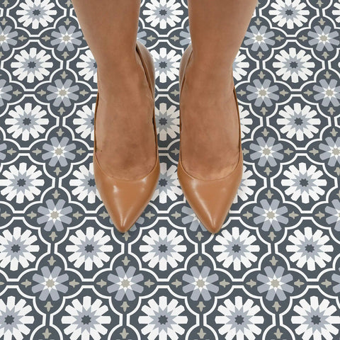 Sevilla Multicolor Peel And Stick Floor Tiles Easy Install No Grout Needed Water Resistant Virgin Vinyl With Textured Low Lustre Finish Durable For Quick DIY Floor Makeover Pack Of Ten Tiles seen beneath brown shoes on Moroccan-style pattern.